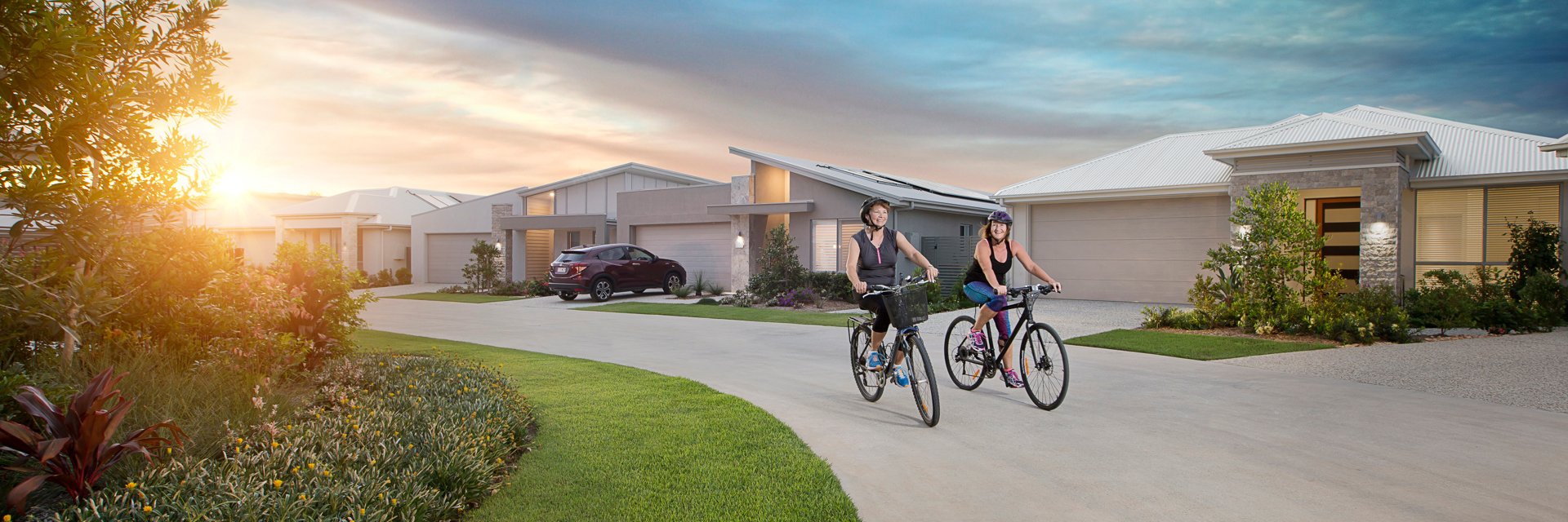 2 ladies ride bikes in the Stockland Halcyon Lakeside community