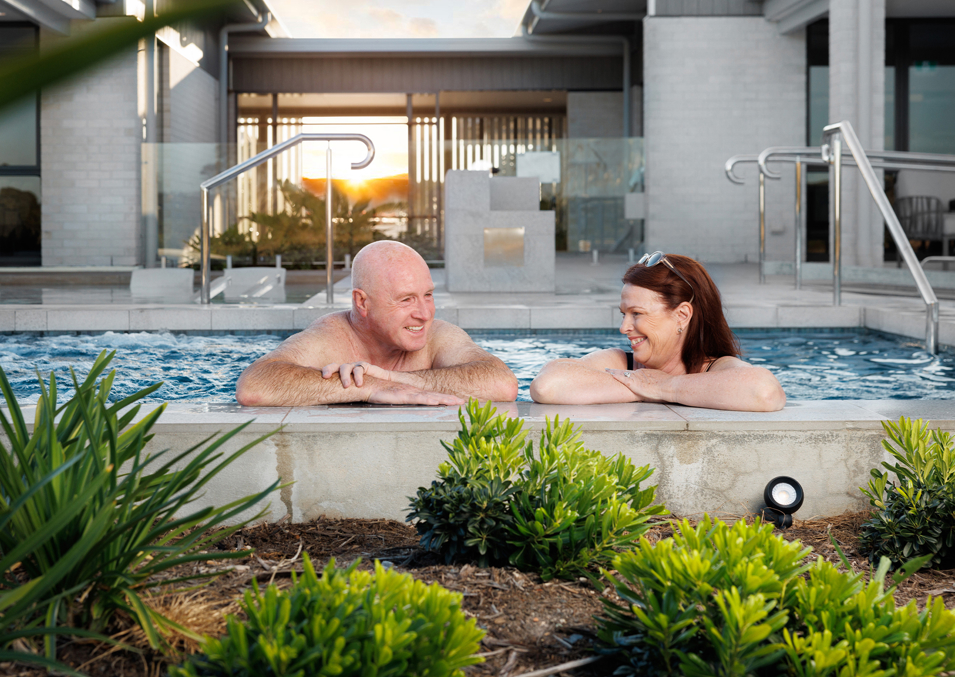 Couple relaxing in the clubhouse pool