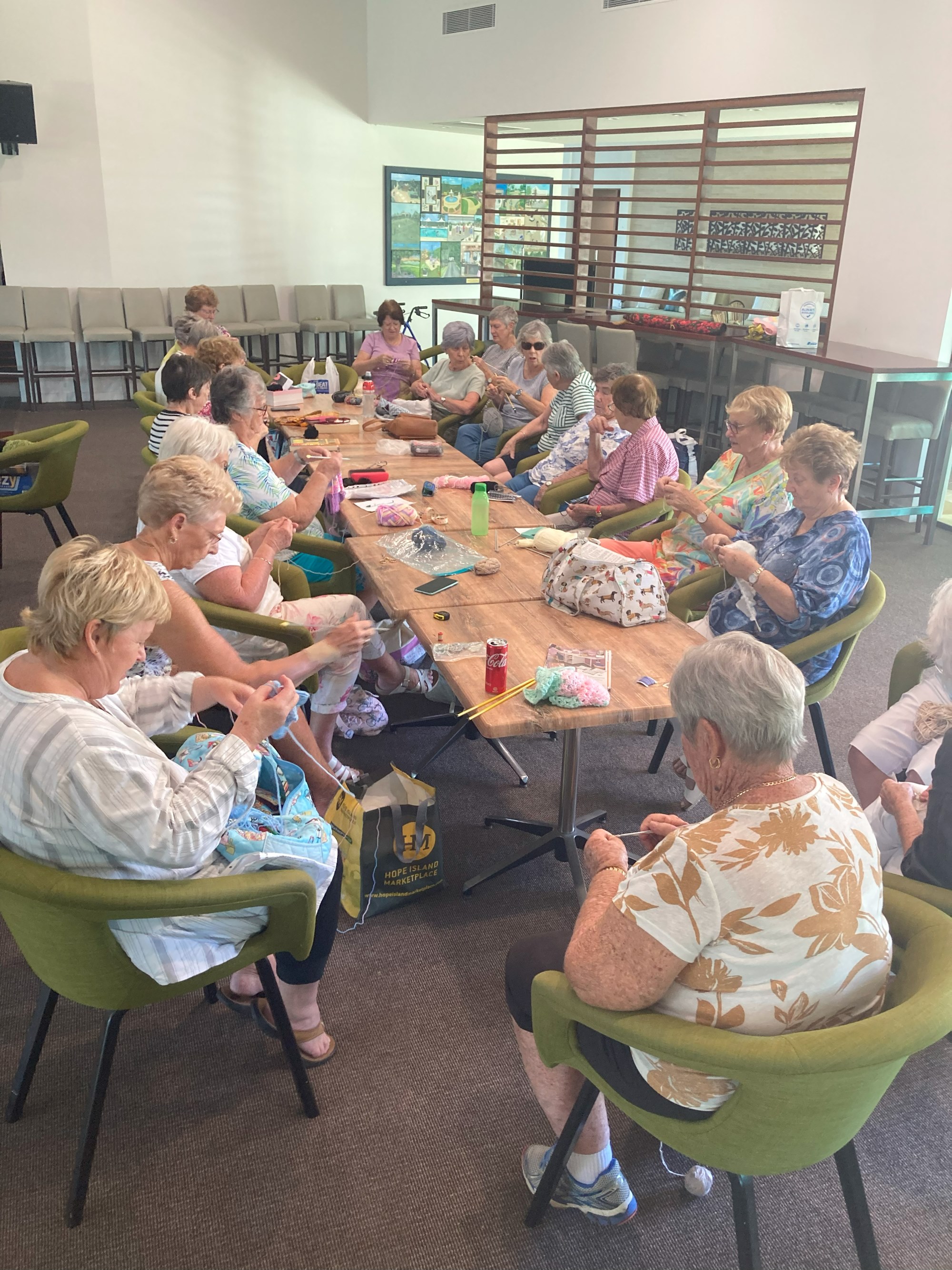 Group of people sitting around a table crafting creations