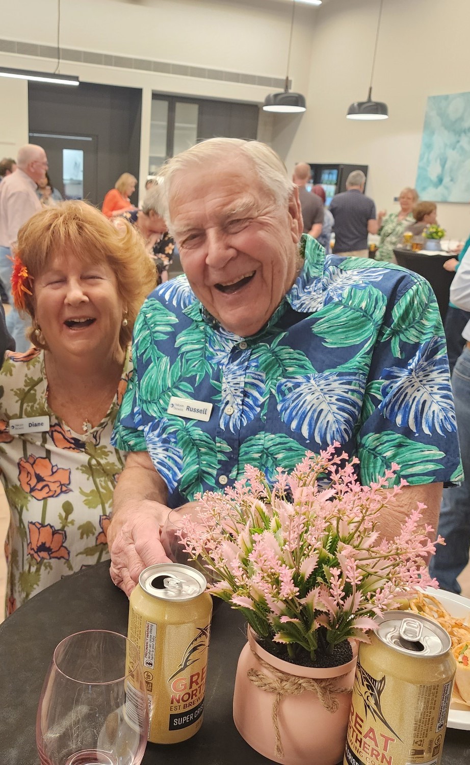 Woman and man laughing or smiling together over a table