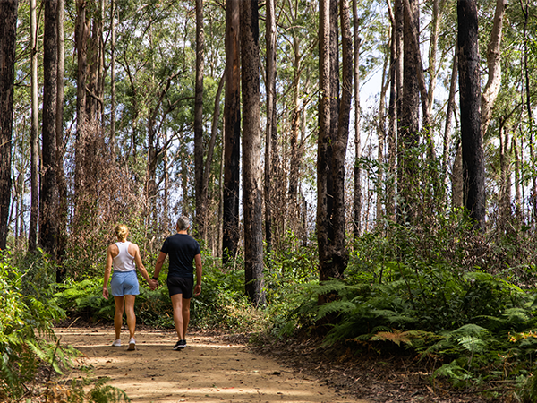 Man and woman walking on hiking trail