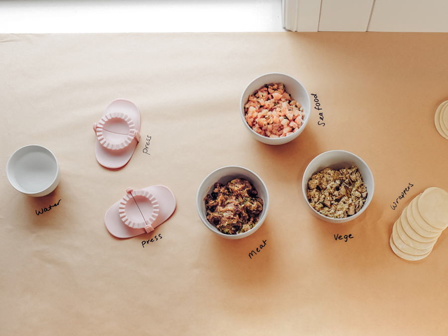 Ingredients and tools laid out on butcher paper to create dumplings