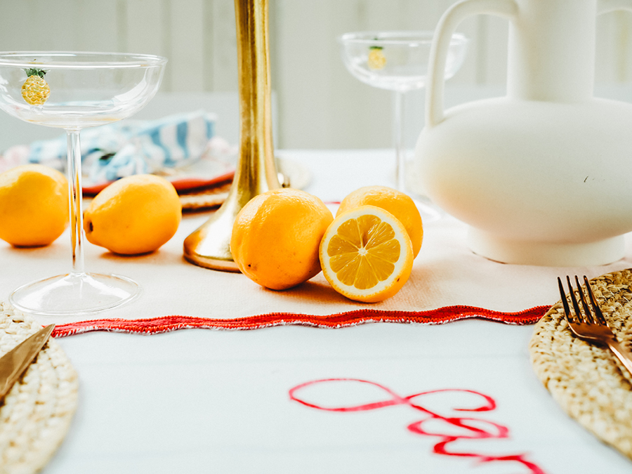 Table styled with glasses, vases and fruit 