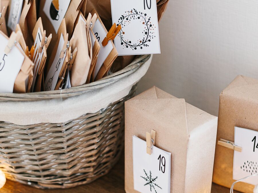 Items wrapped in brown craft paper with dates on them as part of a Christmas advent calendar