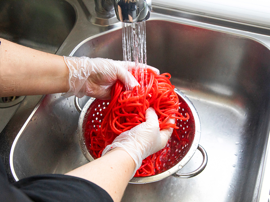 washing rainbow pasta for kids