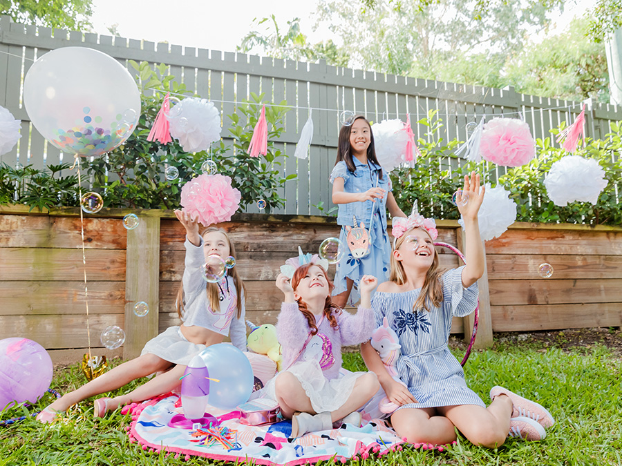 Girls playing outside with bubbles