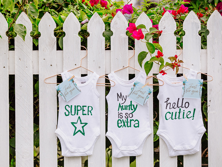 Baby Shower Onezies on a fence