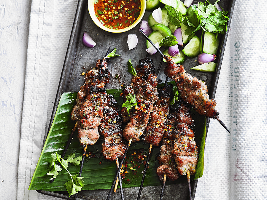 Grilled Thai Coconut Pork Skewers Palm served on a baking tray with banana leaf