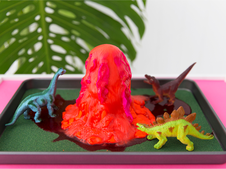 DIY volcano with plastic dinosaurs around it